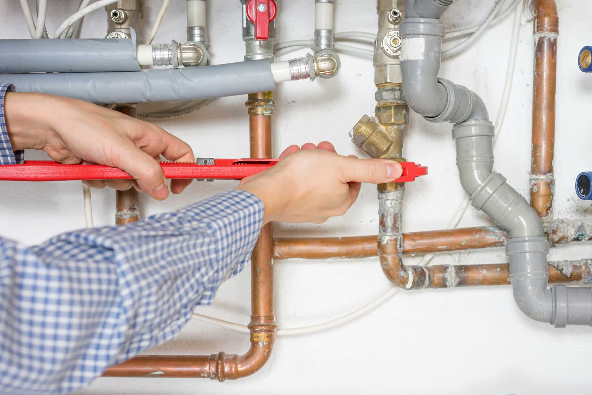 mineral buildup plumber inspecting pipes.