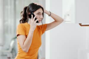 Woman calling a Water Heater Repair Service 
